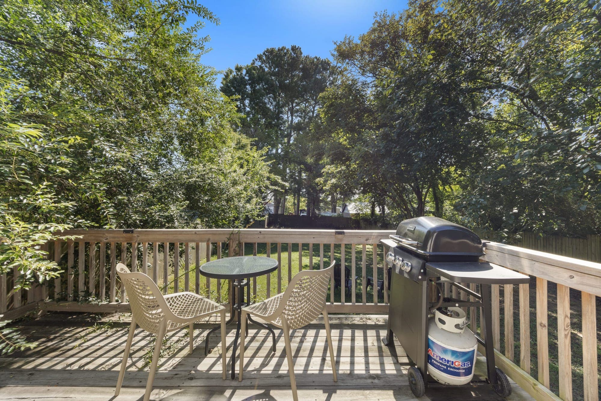 Back deck with a bistro table and grill