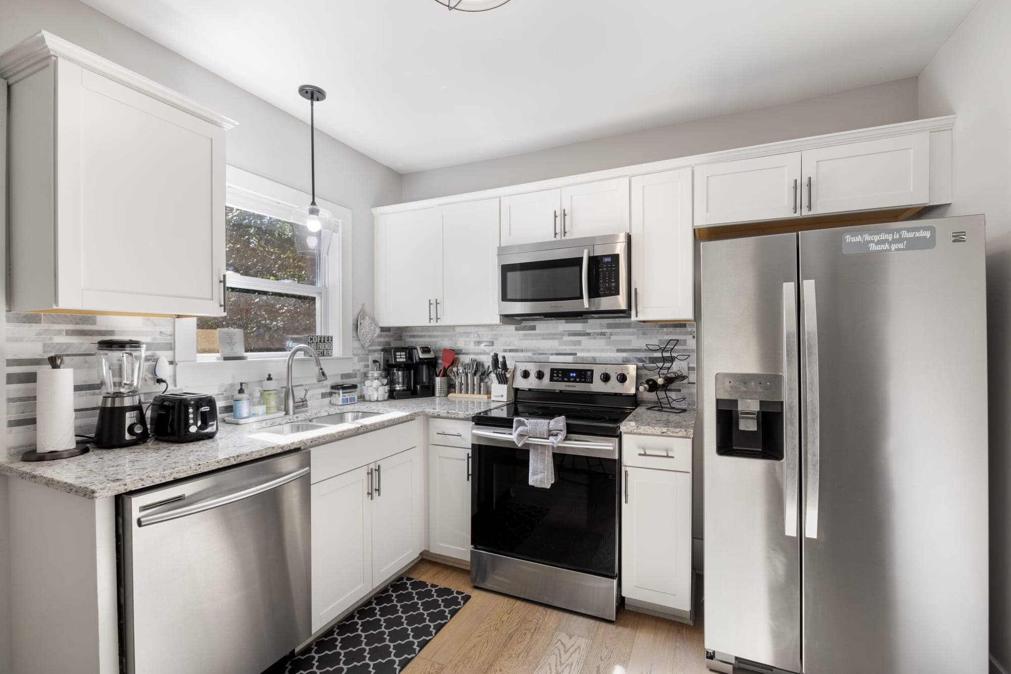 White kitchen with stainless steel appliances
