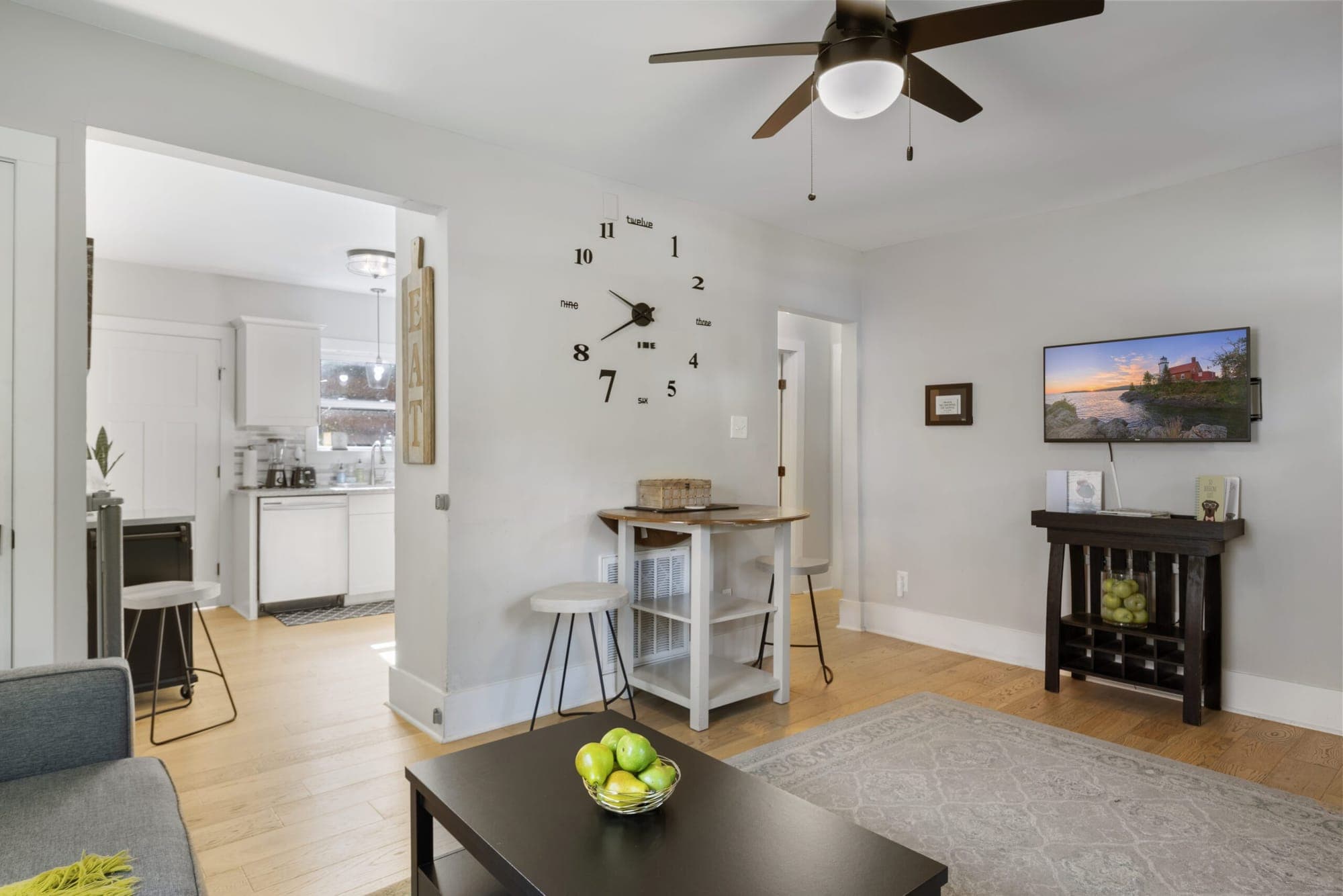 Living room opening to a breakfast bar and TV console