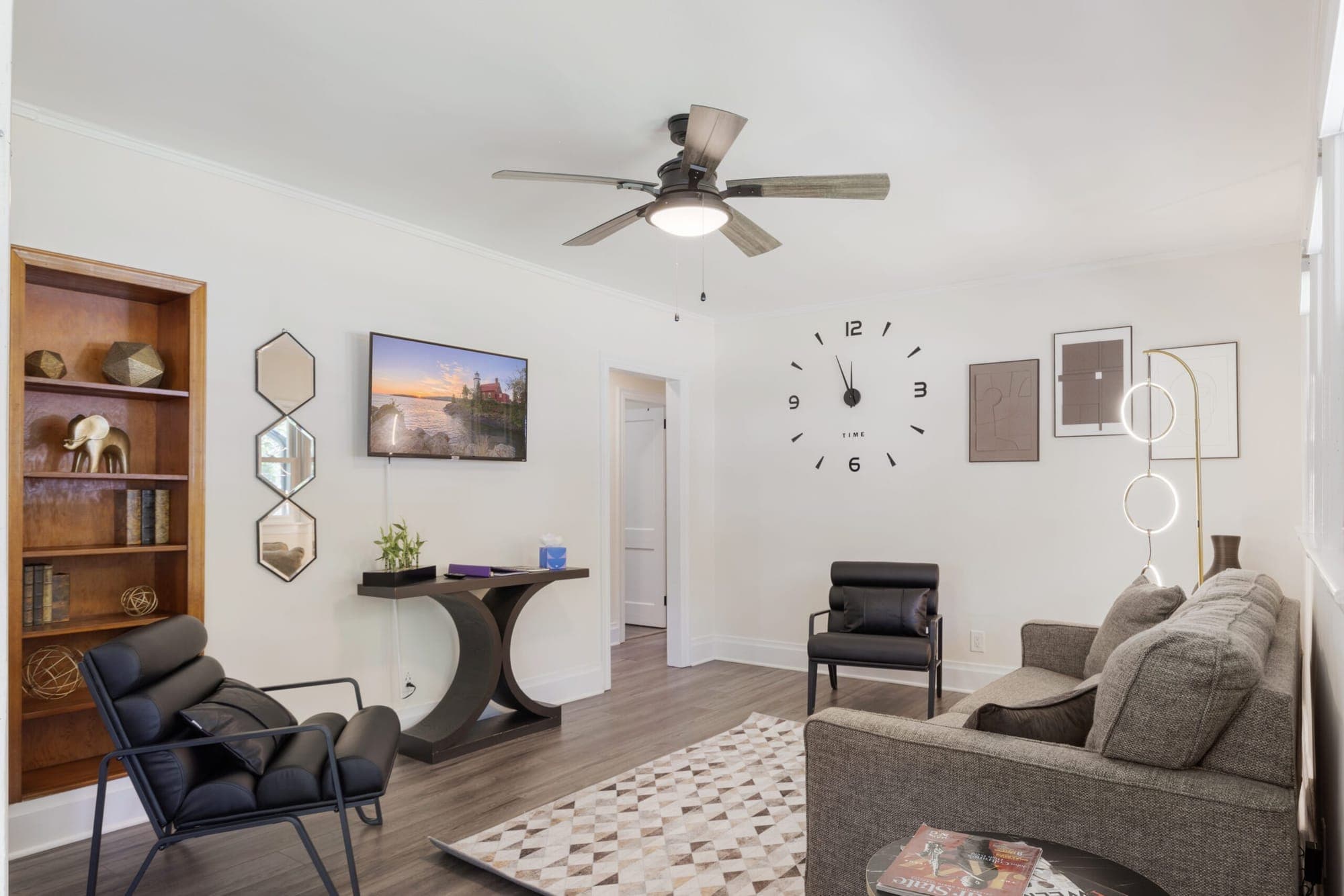 Living room with built-in shelves, TV and ceiling fan