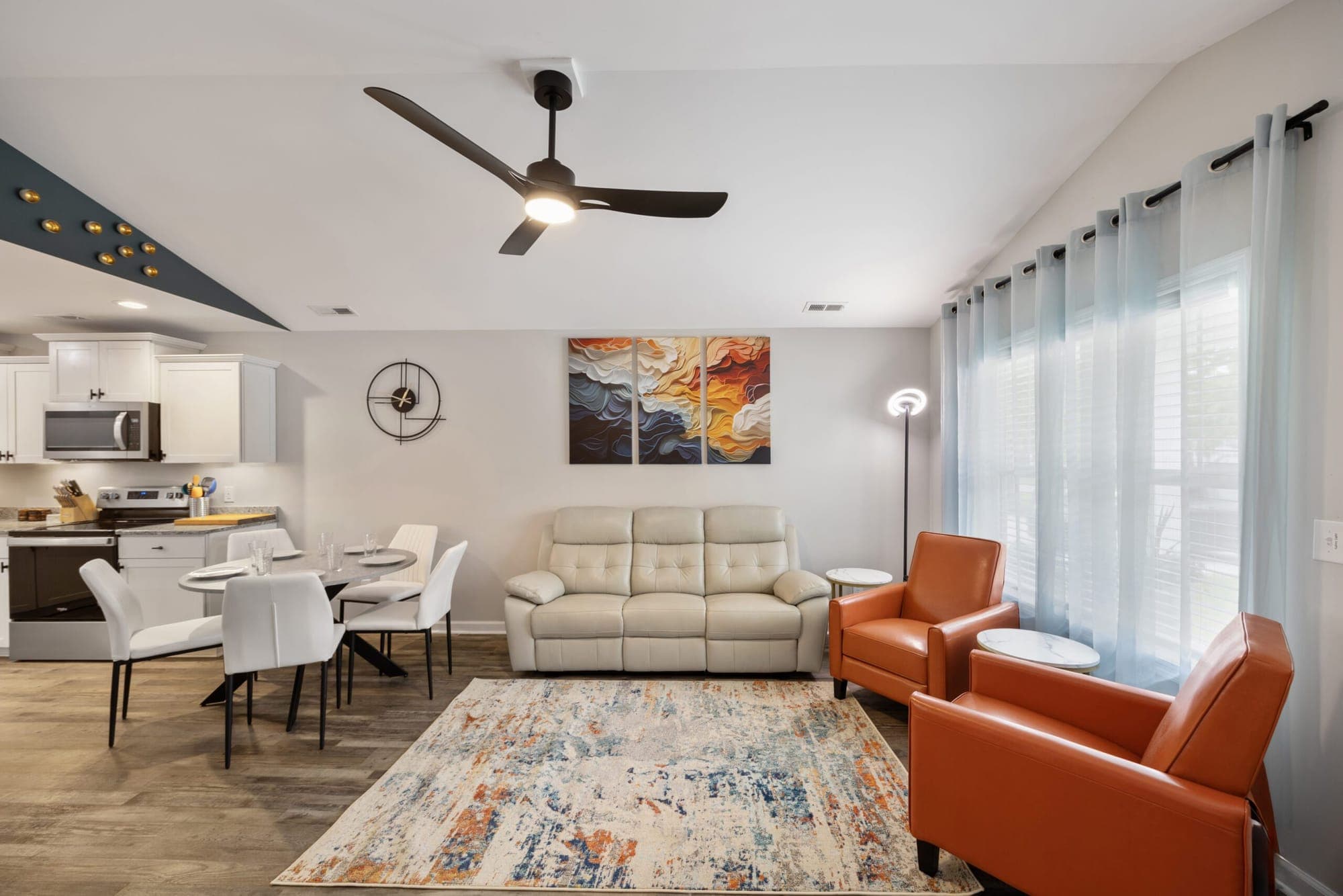 Open living and dining area with a ceiling fan